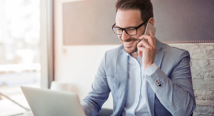 Young Male on His Cell Phone Fostering Client Relationships