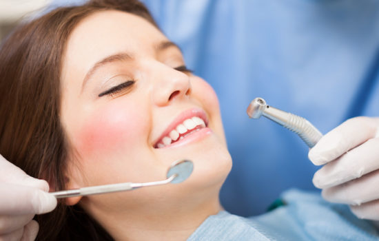 Woman Getting Her Teeth Cleaned at Dentist